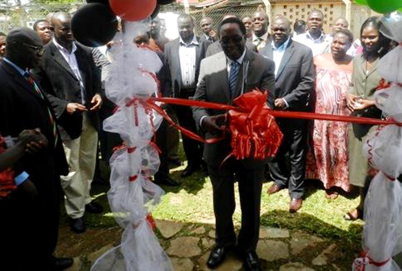 The Vice Chancellor, Prof. John Ddumba-Ssentamu cuts the tape to mark the FHRDC launch on 14th September 2012 at the Kasangati Health Centre, Wakiso Uganda.