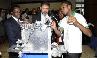 L-R VC-Prof. J. Ddumba-Ssentamu, Dr. Alex Deghan-Director, Office of Science and Technology, USAID and Prof Willaim Bazeyo-Dean, School of Public Health, CHS/ RAN Chief of Party appreciate a robotic demonstration by an Agriculture student at the RAN launch 4th June 2013, Sheraton Kampala Hotel, Uganda
