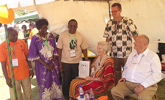 Ms. Ruth Keesling (C) accompanied by her husband Tom(R) and son Frank (standing) after receiving her award from Prof. J.D. Kabasa (3rd L) and Prof. Christine Dranzoa (2nd L) at CoVAB, Makerere University, Kampala Uganda