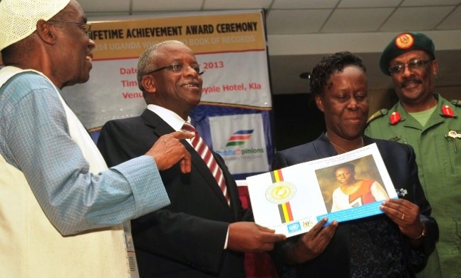 Fmr DVCAA Prof. Lillian Tibatemwa Ekirikubinza (2nd R) receives her award from The Prime Minister Rt. Hon. Amama Mbabazi during the PALITA Award 2013 as H.E. Dr. Boney Katatumba (L) and Gen. Pecos Kutesa witness (R), 18th October 2013, Imperial Royale Hotel, Kampala Uganda