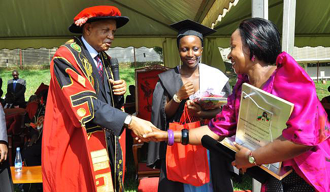 Ms. Sarah Kimala (C) the Best overall and best Sciences student witnesses as Chancellor Prof. George Mondo Kagonyera (L) congratulates her Mother at the 64th Graduation Ceremony, Makerere University, Kampala Uganda
