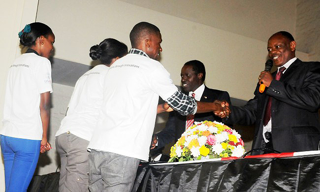 Deputy Vice Chancellor Assoc. Prof. Barnabas Nawangwe (extreme right) joined RAN Chief of Party/ Dean Makerere University School of Public Health Prof. William Bazeyo to congratulate the best team,RAN Innovation Exhibition, 14th March 2014, Makerere University, Kampala Uganda