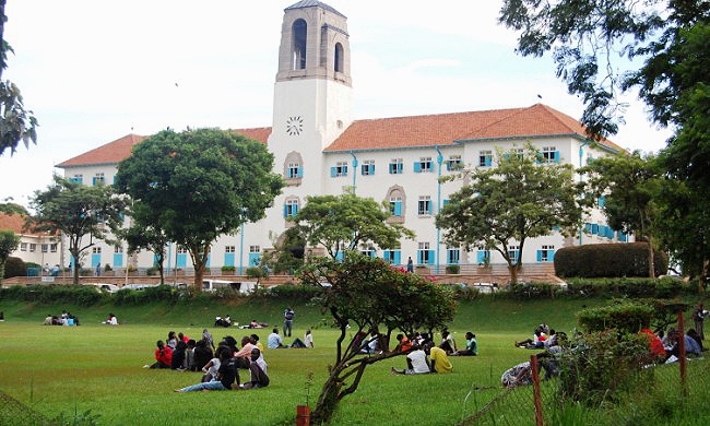 Students hold a discussion in the Freedom Square as overlooked by the Main Administration Building, Makerere University, Kampala Uganda