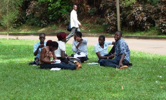 Students hold a discussion in the greens along The Edge Road, Makerere University, Kampala Uganda.