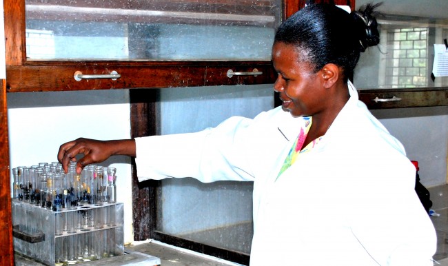 A female graduate student doing research in the laboratory at Makerere University.