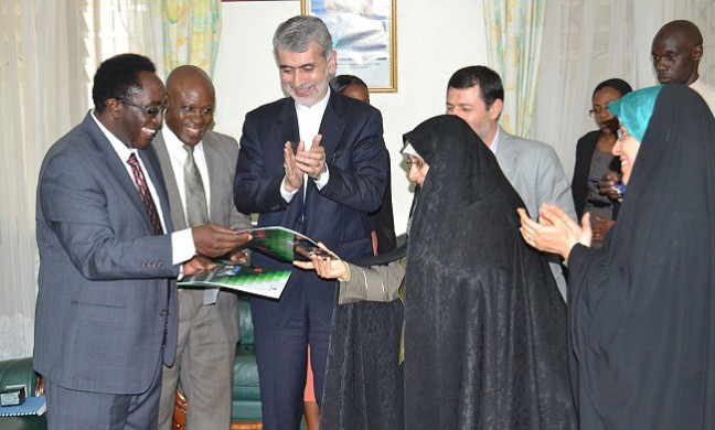 The Vice Chancellor Prof. J. Ddumba-Ssentamu (L) exchanges the signed MoU with  Al-zahra University President-Dr. Ensiyeh Khazali as Iranian Ambassador to Uganda-H.E. Amir Hossein Nik Bin (3rd L) Senior Legal Officer-Mr. Goddy Muhumuza (2nd L), Cultural Counsellor Iranian Embassy Kampala-Akbar Tohidlou (2nd R) and Director International Affairs, Al-Zahra-Dr Marandi Sayyedeh Susan (R) witness on 30th June 2014, Makerere University, Kampala Uganda