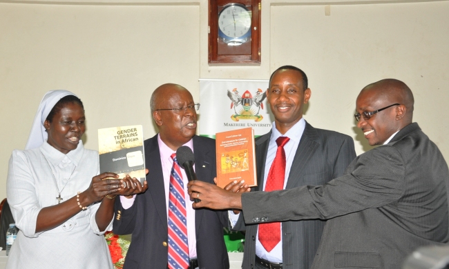 Mr. James Tumusiime (2nd L) flanked by the authors Sr. Dr. Dominica Dipio (L) and Dr. Aaron Mushengyezi (2nd R) and emcee Dr. Danson Kahyana (R) launch the two books on 31st October 2014, Makerere University, Kampala Uganda