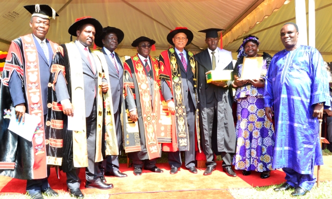 L-R: Academic Registrar-Mr. Alfred Namoah Masikye, Chairperson Appointments Board-Mr. Bruce Kabaasa, Chairperson Council-Eng. Dr. Charles Wana Etyem, Vice Chancellor-Prof. john Ddumba-Ssentamu, Chancellor-Prof. George Mondo Kagonyera, Mr. Adriko Rodney, Mother-Mrs. Onzima and Father-Hon. Alex Onzima, State Minister for Local Government at the 65th Graduation Ceremony