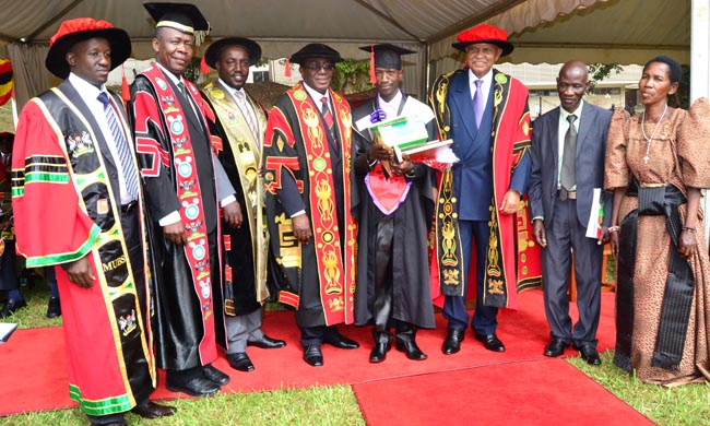 The best student in Humanities,Mr Sewante Luke poses for a photo with the Chancellor and other University Officials