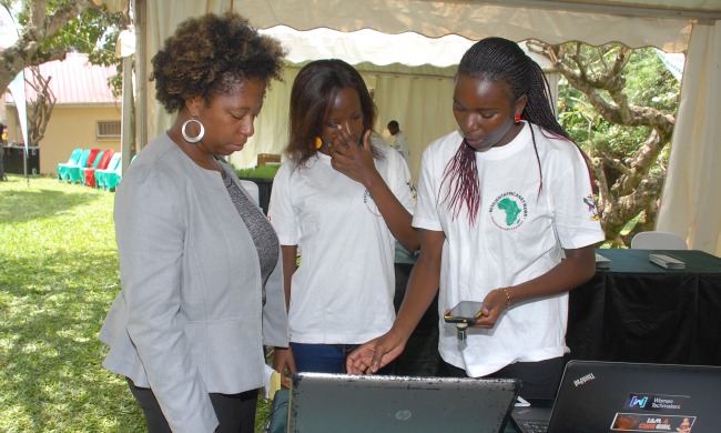 Dr. Ticora V. Jones-Division Chief, HESN, US Global Devt Lab/USAID listens to student innovators during the RIC4ACE Grants Launch 13th August 2014, Makerere University, Kampala Uganda