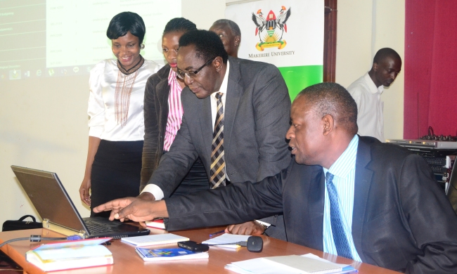 Vice Chancellor-Prof. John Ddumba-Ssentamu (2nd R) assisted by Director-QAD Dr. Vincent Ssembatya and QAD Staff officially launches the Courses Website and Graduate Tracking System, 24th March 2014, CEDAT, Makerere University, Kampala Uganda