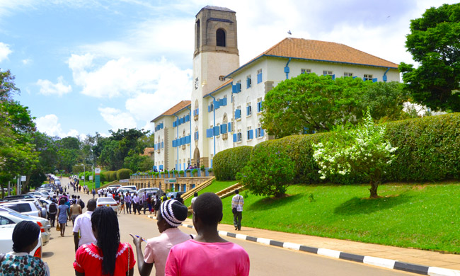 Students walk towards Makerere University Main Building.