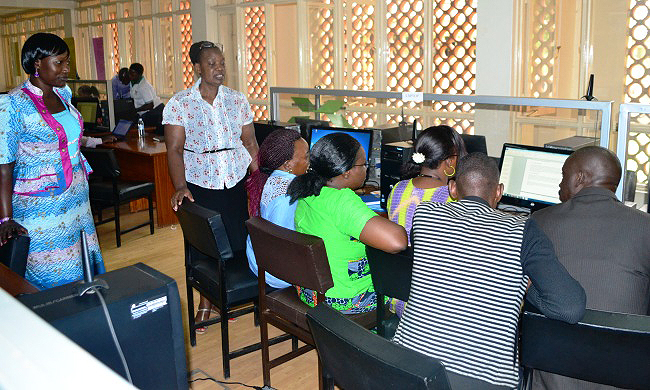 LR: Ms. Faith Akiteng-Librarian CEES and Dr. Hellen Byamugisha-Ag. University Librarian tip participants during the Information Competence and Management Training, 12th June 2015, Main Library, Makerere University, Kampala Uganda