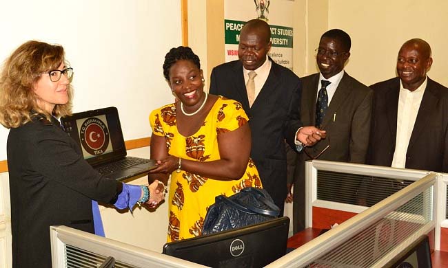 L-R: Turkish Ambassador to Uganda H.E. Ayşe Sedef Yavuzalp hands over UGX100m worth of equipment to Dr. Helen Nkabala-Programme Coordinator as DVCAA-Prof. Ernest Okello Ogwang, Principal CHUSS-Prof. Edward Kirumira and Ag. Head-Peace and Conflict Studies Dept, Dr. Alex Nkabahona witness, 14th September 2015, Makerere University, Kampala Uganda