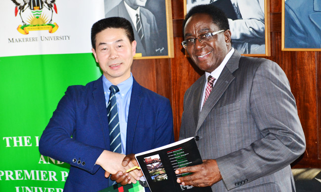 Mr. Zhang Suwen (L) shaking hands with Prof. John Ddumba-Ssentamu.