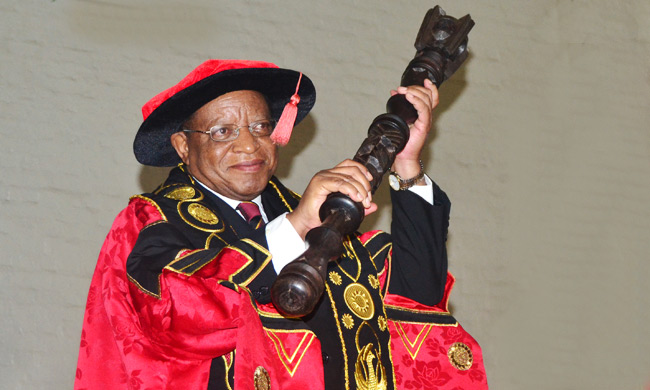 Prof. Ezra Suruma holding the Chancellor's Mace on his installation as Chancellor of Makerere University on 18th January 2016 in the Main Hall, Makerere University..