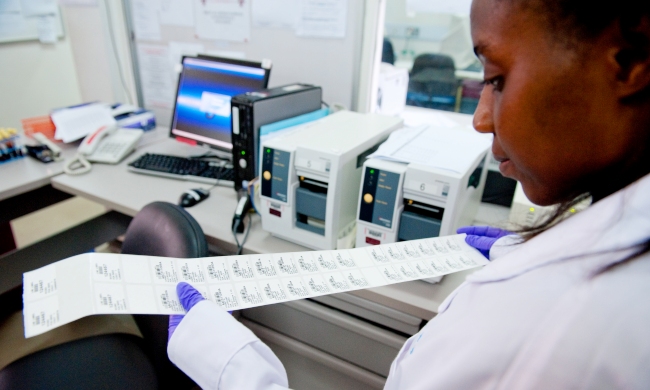 A Student examines Lab test results, College of Health Sciences (CHS), Makerere University, Kampala Uganda