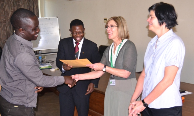 One of the participants (L) receives his certificate from Prof. Mukadasi Buyinza, Director DRGT (2nd L), Prof. Magda Fourie-Malherbe (2nd R) and Dr. Sonja Strydom both from Stellenbosch University at the closing ceremony, 15th Sept 2016, Makerere University, Kampala Uganda