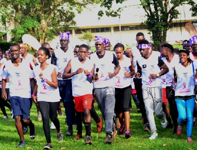 The Chief Runner Robert Kyagulanyi Ssentamu and his Wife Barbra Kyagulanyi flags off students during the  Makerere University Cancer Awareness Run.