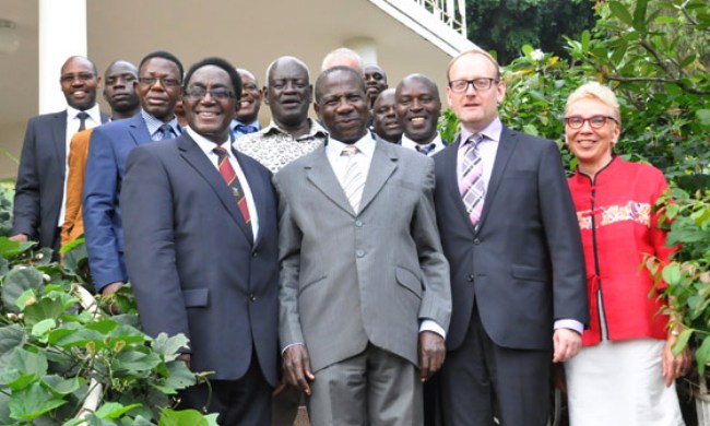 Members of Management from the different institutions and the Swedish Embassy pose for a photo with Minister Hon. Matia Kasaija (C) after the 5yr Uganda-Sweden MoU signing ceremony in Nov 2015