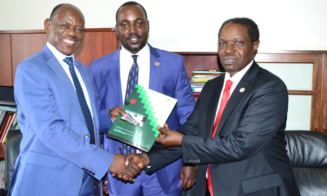 Prof. Barnabas Nawangwe(L) handing over to Prof. William Bazeyo (R) as the Chairperson Makerere University Appointments Board Mr Bruce Kabaasa looks on.