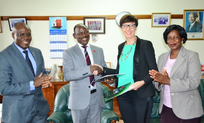 H.E. Stéphanie Rivoal (2nd R) exhanges the signed MoU with Vice Chancellor-Prof. Barnabas Nawangwe (2nd L) as Ag. Directorl Legal Affairs-Mr. Goddy Muhumuza (L) and Head International Office-Ms. Martha Muwanguzi (R) applaud, 29th September 2017, Vice Chancellor's Office, Makerere University, Kampala Uganda