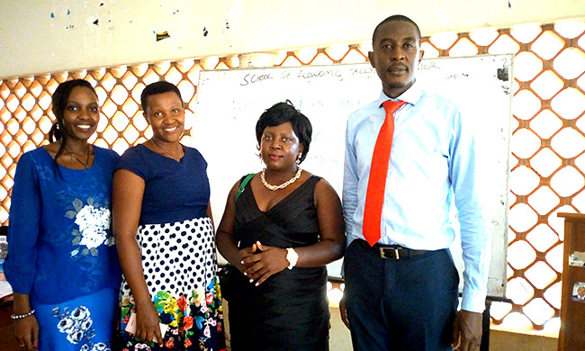 Mr. Jonan Kisakye (R) - Head of Training at the Institute of Insurance of Uganda pose for a photo with colleagues from the Institute and CoBAMS.