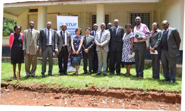 Vice Chancellor-Prof. Barnabas Nawangwe (7th R), Dr. Jeff J.L. Lin and his wife Mei Yvan (6th L & 5th L resp.) with L-R: Mrs. Prossy Katongole-DLA, Mr. Hudson Musoke-DLA, US-Mr. Charles Barugahare, Mr. Goddy Muhumuza, Assoc. Prof. Eria Hisali (Rear), Mr. Patrick Akonyet (Rear), DVCAA-Dr. Ernest Okello Ogwang, Mrs. Dorothy Senoga Zake, Mr. Peter Mubiru, Ms. Naome Kiconco-DLA & Mr. Peter Eneru-DLA after the agreement signing, 13th October 2017, Makerere University, Kampala Uganda  )