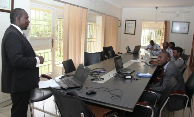 A member of the Directorate of Regulation and Legal Services, NITA-U-Mr. Baker Birikujja (L) interacts with the RAN Team during the sensitization, 6th September 2017, RAN Kololo Offices, MakSPH, Makerere University, Kampala Uganda