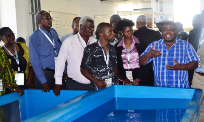 Participants engage during the visit to the fish node in LUANAR Image:RUFORUM
