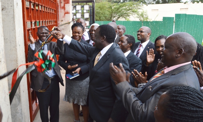 The Chairperson Council-Eng. Dr. Charles Wana-Etyem cuts the tape signifying the reopening of the Main Gate on 14th December 2017, Makerere University, Kampala Uganda.