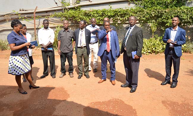 DVCFA-Prof. William Bazeyo (3rd R) makes his observations to the contractor (4th L) as R-L: Mr. Gordon Murangira, Dr. Charles Ibingira, Eng. Justus Akankwasa (rear), Mr. Paul Funa, Mr. Grace Kityo, Eng. Joseph Jurua, Dr. Margaret Wandera and Eng. Christina Kakeeto take note. This was during the inspection of Phase I of renovations at the Makerere University Hospital, 23rd January 2018.