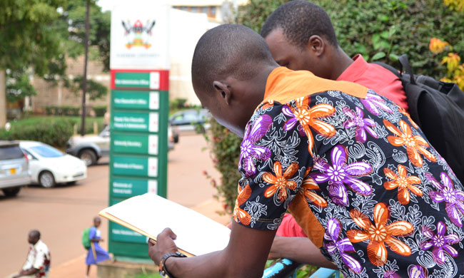 Students standing near the Makerere University Main Building.