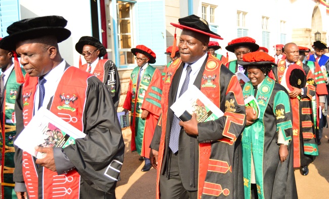 Principal, CoCIS-Prof. Tonny Oyana (2nd L) flanked by Dr. Gilbert Maiga (L), Deputy Principal-Dr. Agnes Rwashana Semwanga (R), Dr. George William Kiyingi & Dr. Engineer Bainomugisha (background) and other Staff in the Academic Procesession on Day Two of the 68th Graduation Ceremony, 17th January 2018, Makerere University, Kampala Uganda