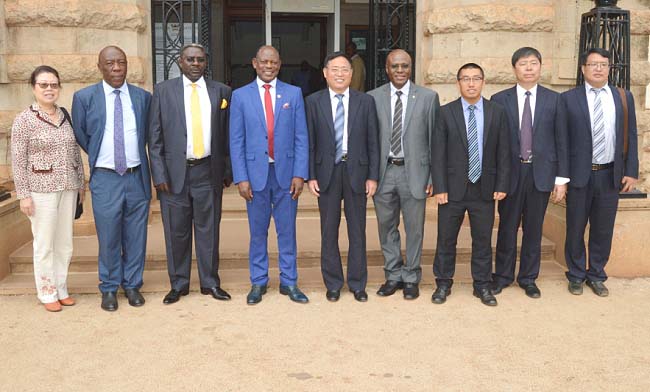 Secretary of the Communist Party and Chancellor STDU-Prof. Wang Yuesen (C) with Prof. Barnabas Nawangwe (4th L), Amb. Henry Mayega (3rd L) and L-R: Fenghai Ping, Prof. Henry Alinaitwe, Mr. Goddy Muhumuza, Wang Shu Hai, Wang Xiao Ling and an STDU official after the MoU signing, 6th February 2018, Makerere University, Kampala Uganda.