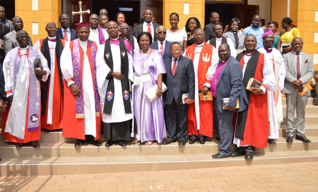 Rev. Canon Onesimus Asiimwe (4th L) and his wife (5th L) shortly after being installed by the Archbishop of the Church of Uganda Rt. Rev. Stanley Ntagali (3rd L) as the Chaplain of St. Francis Chapel, Makerere University on 18th February 2018. He is joined in the photo by the Chancellor-Prof. Ezra Suruma (6th R), Vice Chancellor-Prof. Barnabas Nawangwe (R), University Leadership, Clergy and other dignitaries.