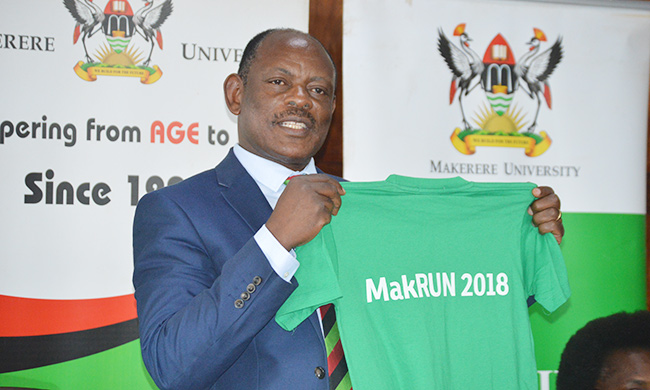 Vice Chancellor Prof. Barnabas Nawangwe display the #MakRun T-Shirt during the press briefing held on Friday 16th March 2018.