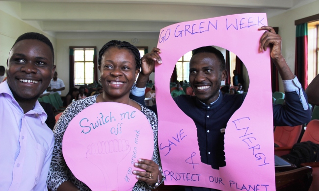 Director of Estates and Works Department (EWD) Eng. Christina Kakeeto (C) together with some students parading some of the messages on sustainable energy efficiency practices during the campaing launch, 27th February 2018, Senior Common Room, Main Building, Makerere University, Kampala Uganda