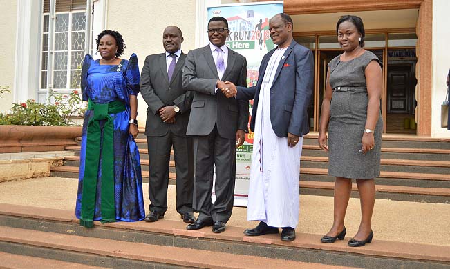 The Katikkiro of Buganda Ow’ekitiibwa Charles Peter Mayiga (C) shakes hands with Vice Chancellor-Prof. Barnabas Nawangwe (2nd R) shortly after accepting the invitation to be the Chief Runner at MakRun2018. Prof. Fred Masagazi Masaazi (2nd L), Dr. Florence Nakayiwa (L) and Ms. Gloria Nakyeyune (R) formed part of the delegation to Bulange, Mengo on 5th March 2018. The Katikkiro graciously accepted Makerere University’s invitation and vowed to give his full support to the fundraising run.