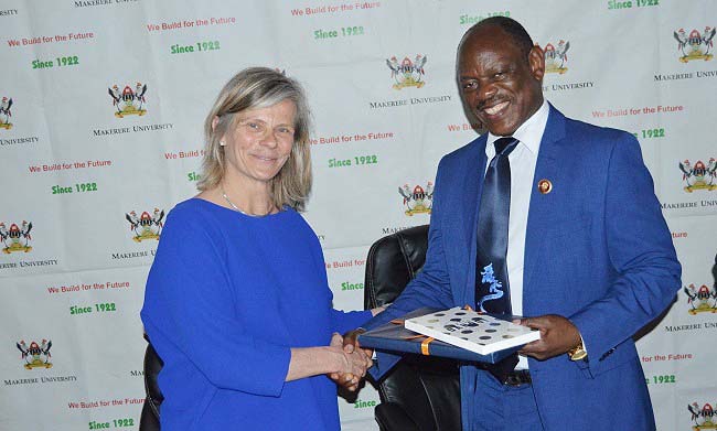 The Vice Chancellor Prof. Barnabas Nawangwe (R) receives souvenirs from Rector VUB-Prof. Dr. Caroline Pauwels (L) after the courtesy call on 19th April 2018, Makerere University, Kampala Uganda.