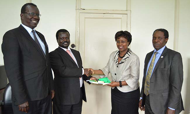 Incoming Director-Mr. Andrew Abunyang (2nd L) shakes hands with outgoing Director-Mrs. Dorothy Sennoga Zake (2nd R) as Acting Vice Chancellor & DVCFA-Prof. William Bazeyo (R) and Director Internal Audit-Mr. Walter Yorac Nono (L) witness, 17th April 2018, HRD, Makerere University, Kampala Uganda.