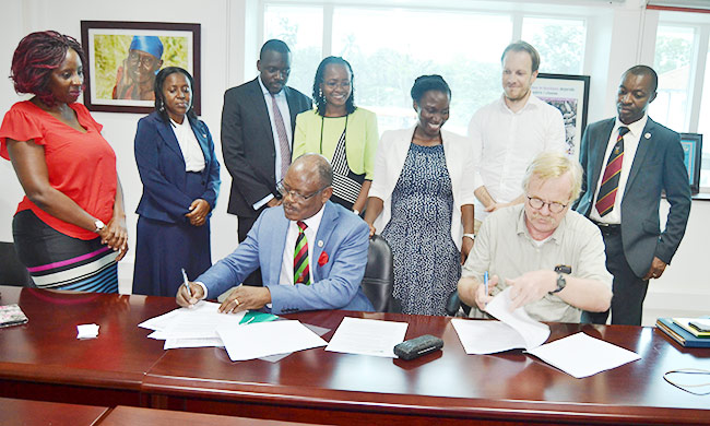 Prof. Barnabas Nawangwe(L) and Mr. Wim Stoffers(R) sign the agreement.