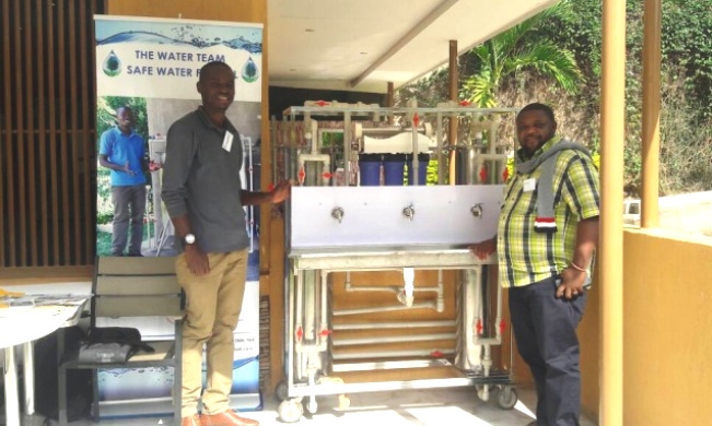 One of the Article authors and Lead Innovator on the Water Purification Innovation-Timothy Kayondo poses for a photo with a participant during the physical engagement with the Oxfam International Team, 12th - 17th March 2018, Kampala Uganda