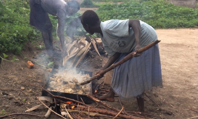 A Cassava flour mixture being roasted on metallic pans – an activity main undertaken by women. Image:RUFORUM