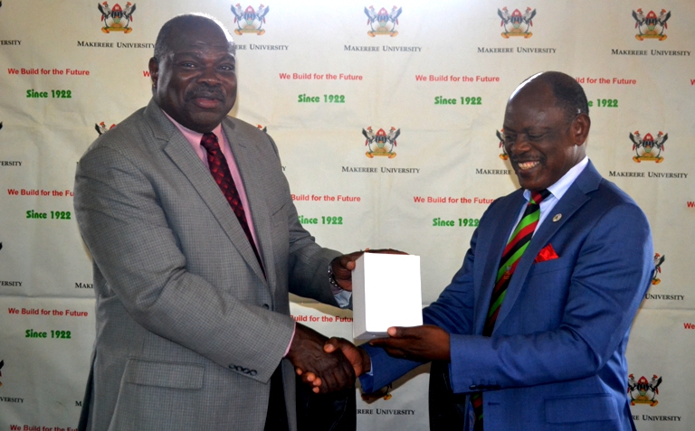 The Vice Chancellor of Makerere University Prof. Barnabas Nawangwe Presenting a gift to the Secretary General of African Research Universities Alliance (ARUA) Prof. Ernest Aryeetey.