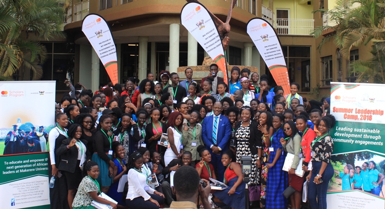 The Vice Chancellor together with Dr. Florence Nakayiwa posing for a photo with students.