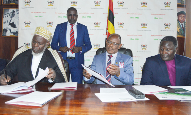 H.E Sheikh Shaban Ramadhan Mubajje (Left) and Prof Barnarbas Nawangwe sign the agreement as Bishop Joshua Lwere and  Mr. Henry Mwebe (standing), the Mak Director of Legal Affairs look on.