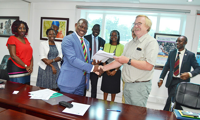 Vice Chancellor, Prof. Barnabas Nawangwe (L) shakes hands with Mr. Wim Stoffers-Head of Democratic Governance Facility (DGF) after signing the Partnership Agreement on 23rd April 2018, SWGS, Makerere University, Kampala Uganda