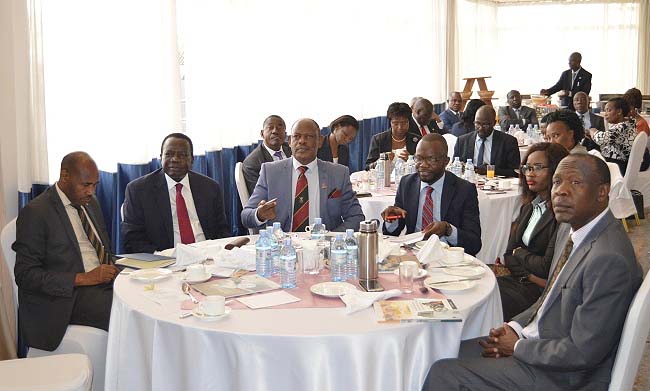 The Chairperson Council-Eng. Dr. Charles Wana-Etyem (2nd L) flanked by Vice Chancellor-Prof. Barnabas Nawangwe (3rd L), University Secretary-Mr. Charles Barugahare (L), Academic Registrar-Mr. Alfred Namoah Masikye (R) Guild President-H.E. Papa Were Salim (3rd R) and Vice Guild President-H.E. Kokoi Fiona (2nd R) at the 2nd Self-assessment Report Dissemination Breakfast 10th May 2018, Golden Tulip Hotel, Kampala Uganda