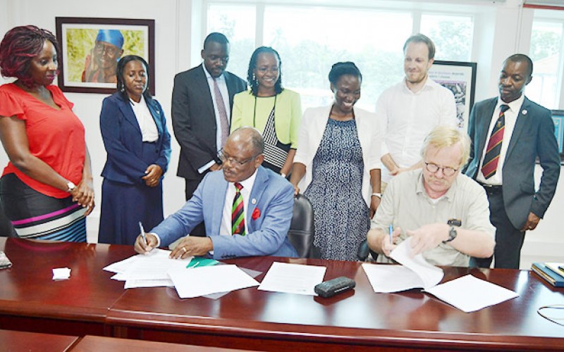 The Vice Chancellor Prof. Barnabas Nawangwe(L) and DGF Head Mr. Wim Stoffers (R) sign the agreement on 23rd April 2018, SWGS, CHUSS, Makerere University, Kampala Uganda